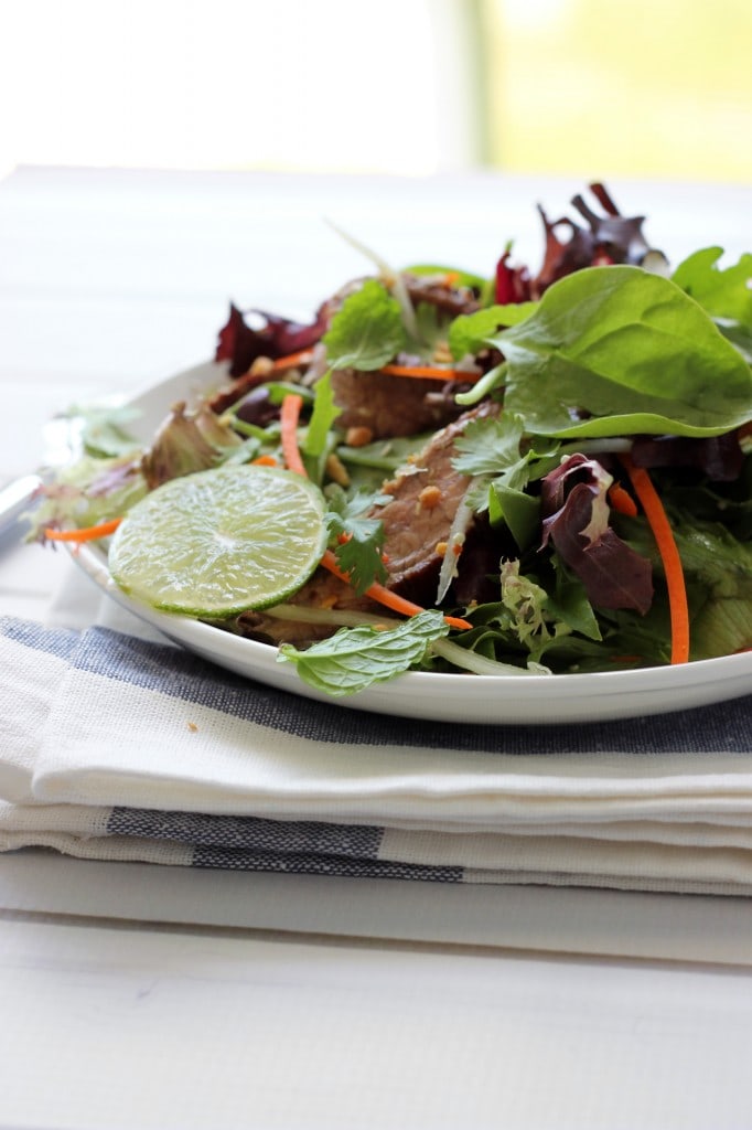 Thai beef salad - A colorful Thai beef salad packed with flavors of fish sauce, shallots, lime juice, mint, cilantro, lemongrass, cucumbers, carrots and wonderful garnishes.