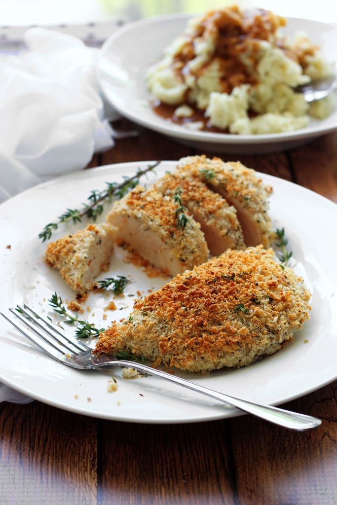 Easy baked Parmesan and herb crusted chicken breasts are baked in the oven with panko breadcrumbs, Parmesan cheese, Italian seasoning and sage.
