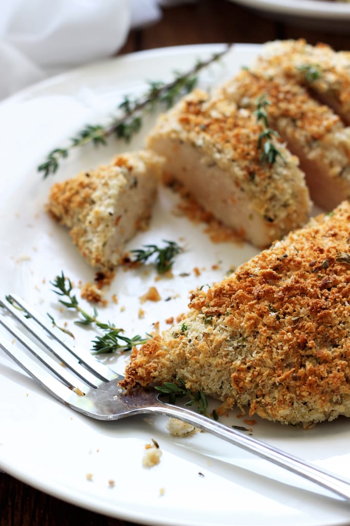 Easy baked Parmesan and herb crusted chicken breasts are baked in the oven with panko breadcrumbs, Parmesan cheese, Italian seasoning and sage.
