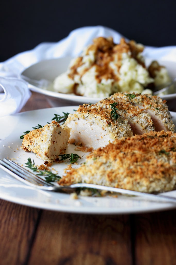 Easy baked Parmesan and herb crusted chicken breasts are baked in the oven with panko breadcrumbs, Parmesan cheese, Italian seasoning and sage.