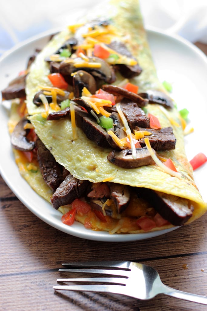 An IHOP copycat recipe for Big Steak Omelette: a giant omelette stuffed to the brim with steak, bell peppers, onions, cheese, hash browns and mushrooms!