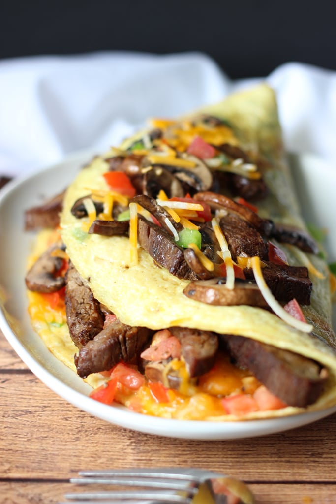 An IHOP copycat recipe for Big Steak Omelette: a giant omelette stuffed to the brim with steak, bell peppers, onions, cheese, hash browns and mushrooms!