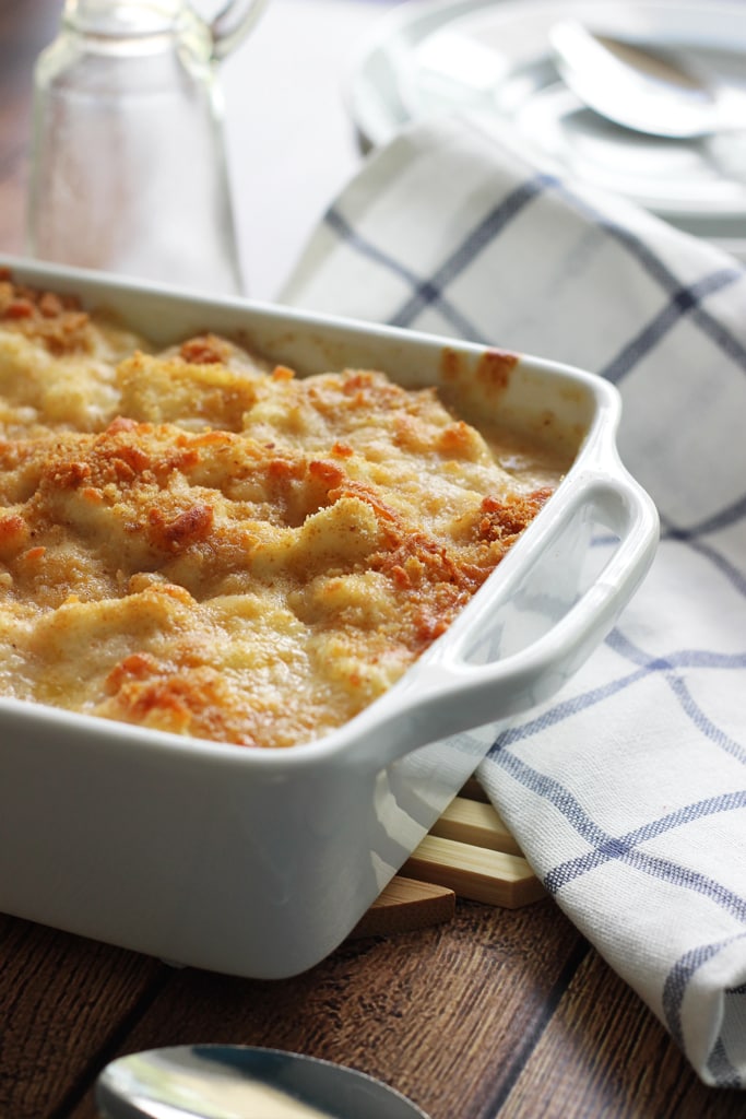 A cheesy, creamy cauliflower Au Gratin casserole with rich Bechamel sauce topped with a crusty layer of breadcrumbs and cheese.