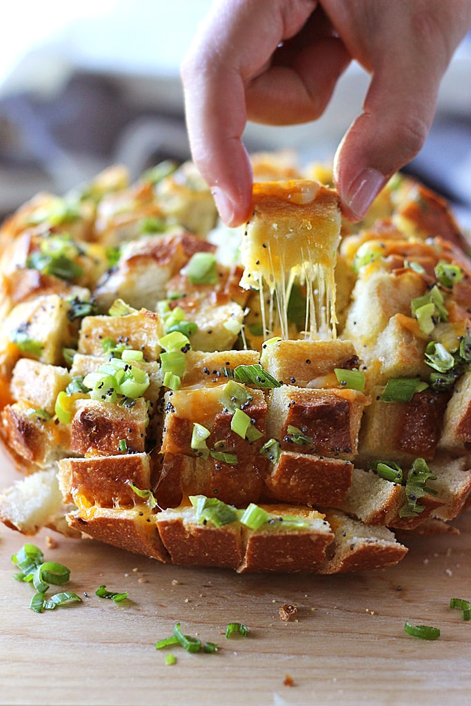 Bloomin' onion bread is the appetizer you're looking for to 'wow' guests. Cheesy, gooey strings of cheese meets crunchy, fresh green onions and poppy seeds!