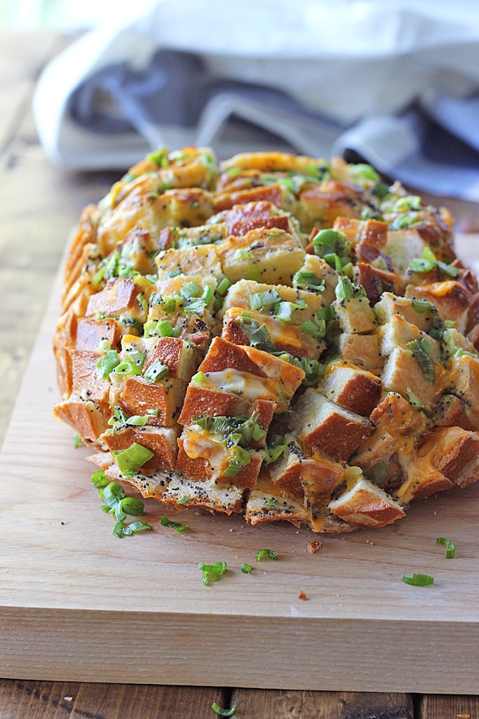 Bloomin' onion bread is the appetizer you're looking for to 'wow' guests. Cheesy, gooey strings of cheese meets crunchy, fresh green onions and poppy seeds!