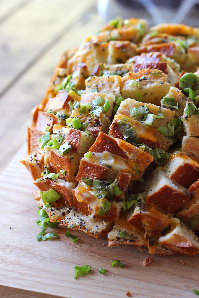 Bloomin' onion bread is the appetizer you're looking for to 'wow' guests. Cheesy, gooey strings of cheese meets crunchy, fresh green onions and poppy seeds!