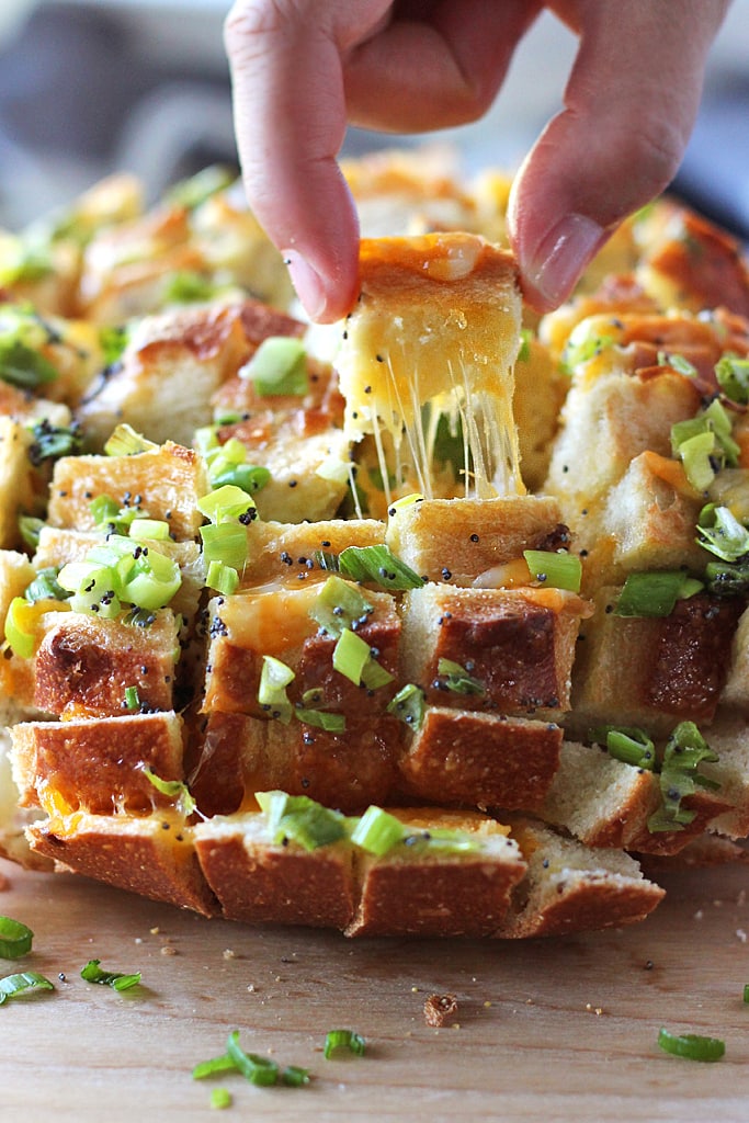 Bloomin' onion bread is the appetizer you're looking for to 'wow' guests. Cheesy, gooey strings of cheese meets crunchy, fresh green onions and poppy seeds!