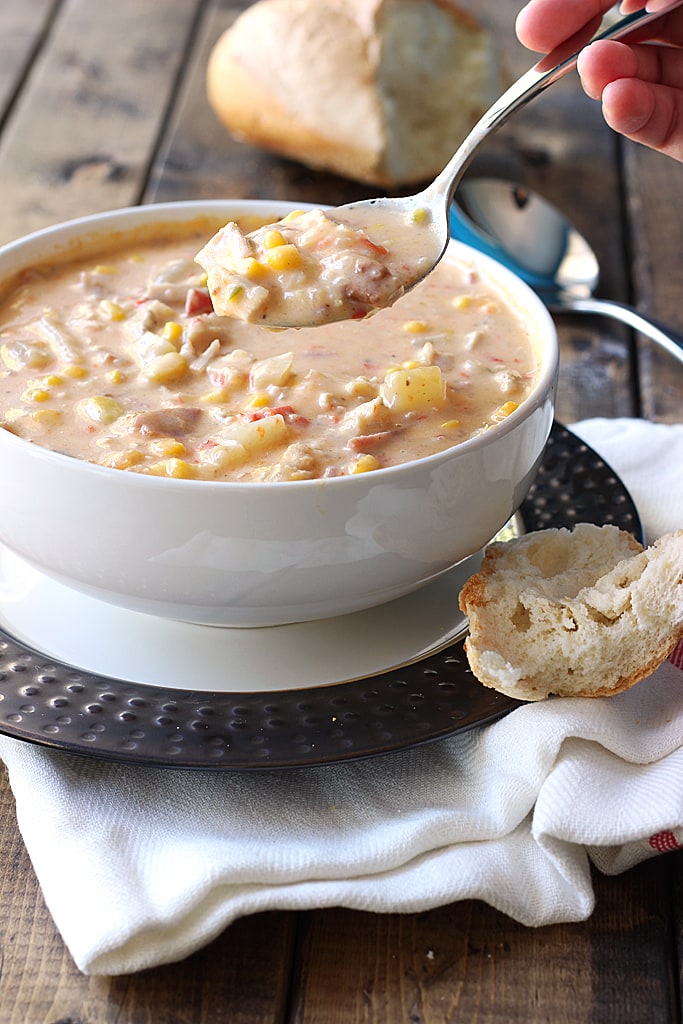 Creamy spicy chicken and corn chowder is the perfect soup for fall. With rotisserie chicken, corn, bacon, jalapenos, bell peppers and cheddar cheese.