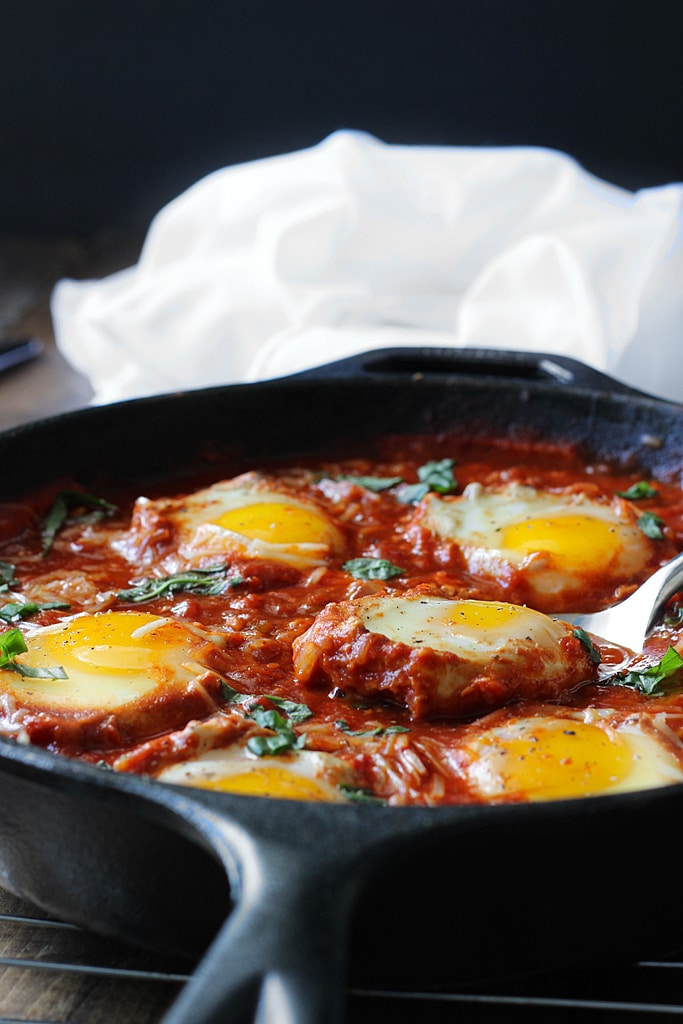 Eggs in Hell are a quick and spicy way to enjoy your eggs in the morning. With plenty of spices, Parmesan cheese and eggs simmered in tomato sauce.