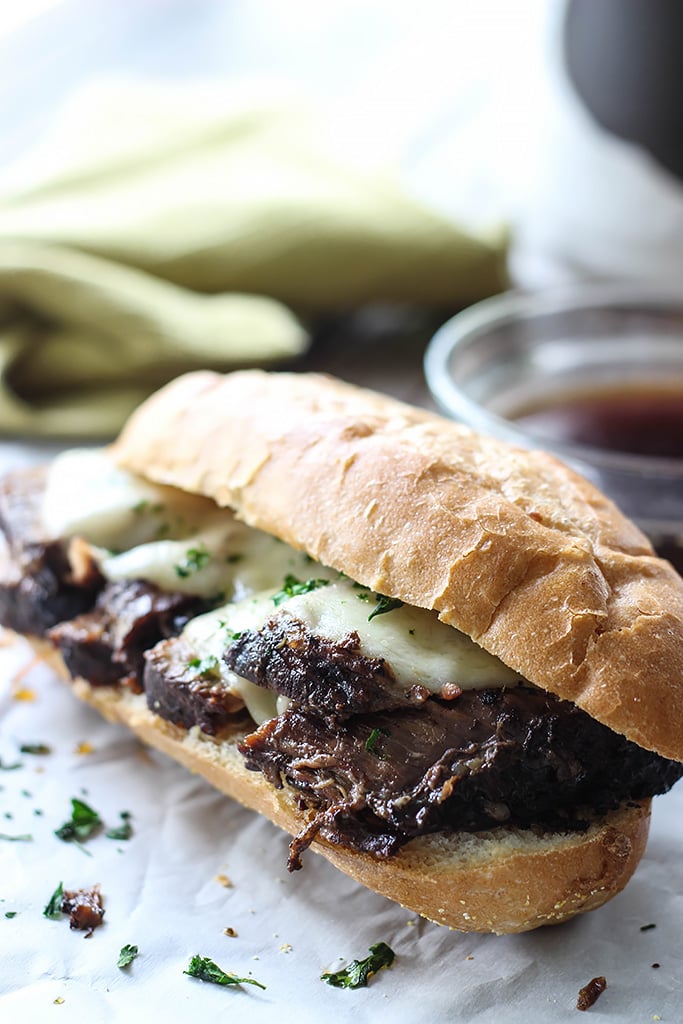 A slow cooker French Dip sandwich that's a perfect hot fix for cool weather. Dip, dip, dip it in some hearty au jus gravy!