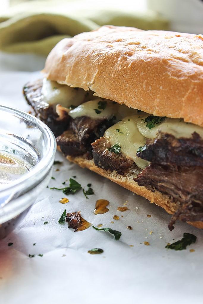 A slow cooker French Dip sandwich that's a perfect hot fix for cool weather. Dip, dip, dip it in some hearty au jus gravy!