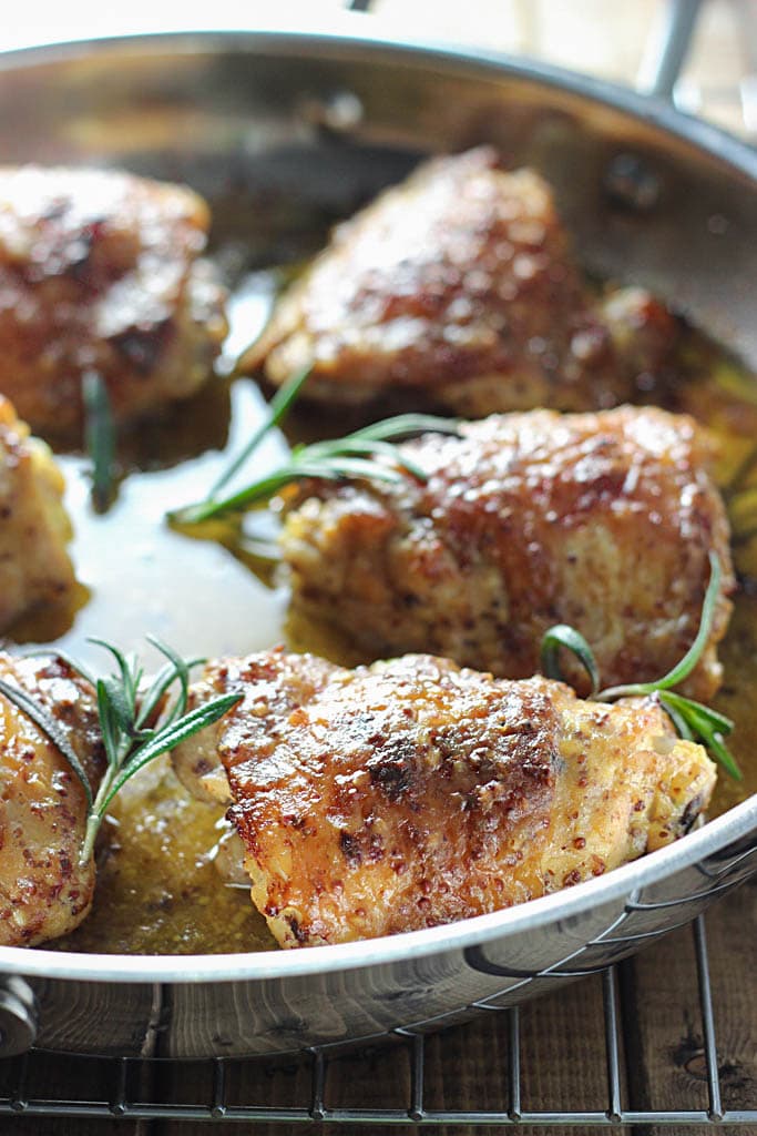 Perfectly seared and baked chicken thighs in a honey mustard sauce with hints of rosemary make this baked honey mustard chicken a great dinner.