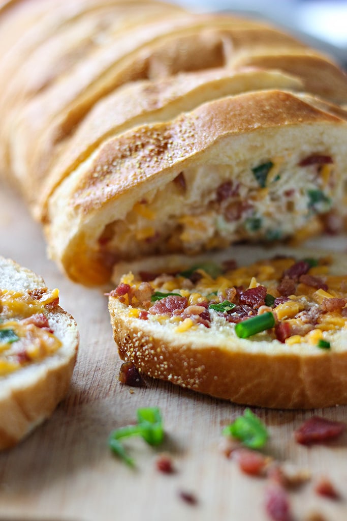 An easy cheesy bacon bread appetizer for a big crowd. With creamy butter, cheddar cheese, bacon pieces and green onions! 