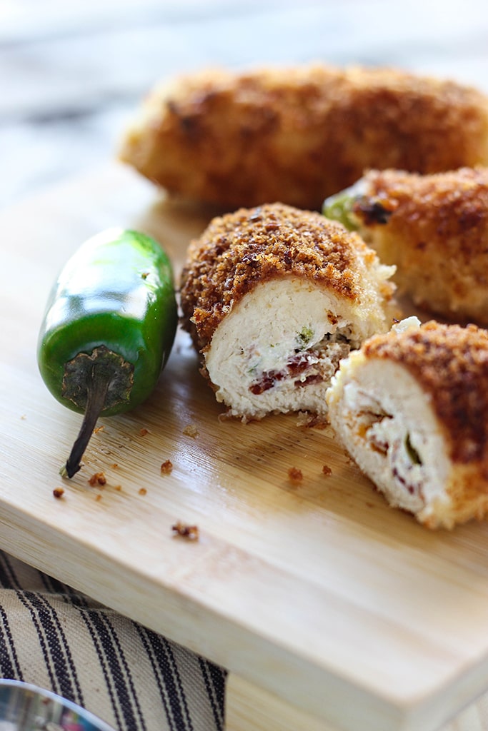 Jalapeno popper chicken is a fun way to snack with cream cheese, bacon bits and jalapenos stuffing in a crispy breaded chicken!