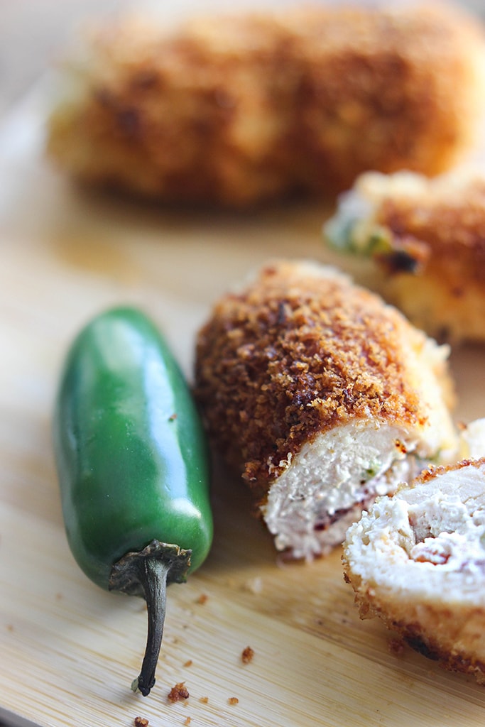 Jalapeno popper chicken is a fun way to snack with cream cheese, bacon bits and jalapenos stuffing in a crispy breaded chicken!