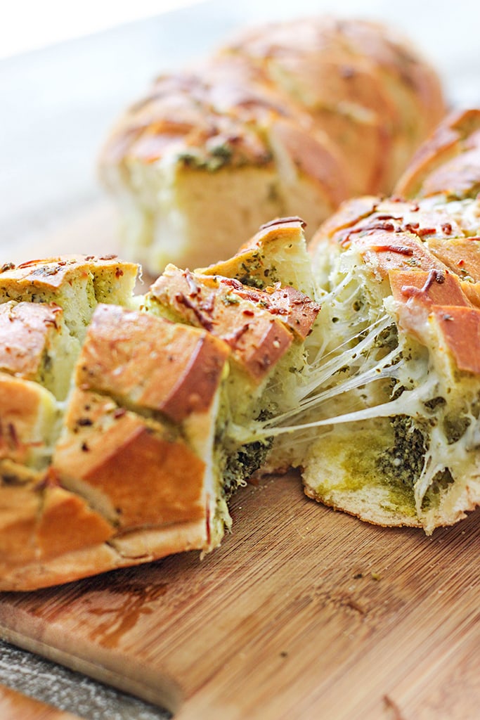 There's plenty of cheese action in this cheesy pesto pull-apart bread. Feed a crowd with this easy 4 ingredient appetizer.