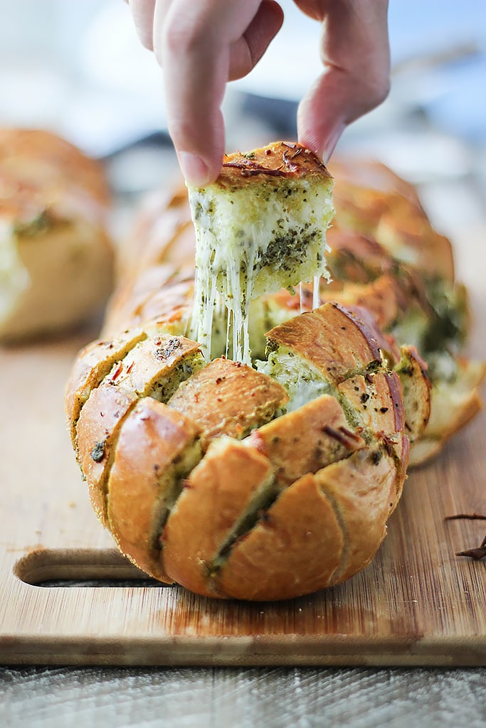 There's plenty of cheese action in this cheesy pesto pull-apart bread. Feed a crowd with this easy 4 ingredient appetizer.