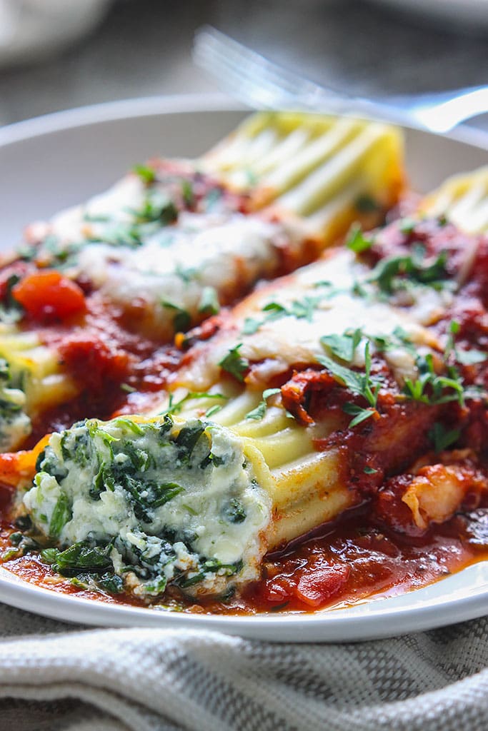 This spinach and three cheese manicotti is perfect for Italian food loving vegetarians. The perfect comfort food this fall.