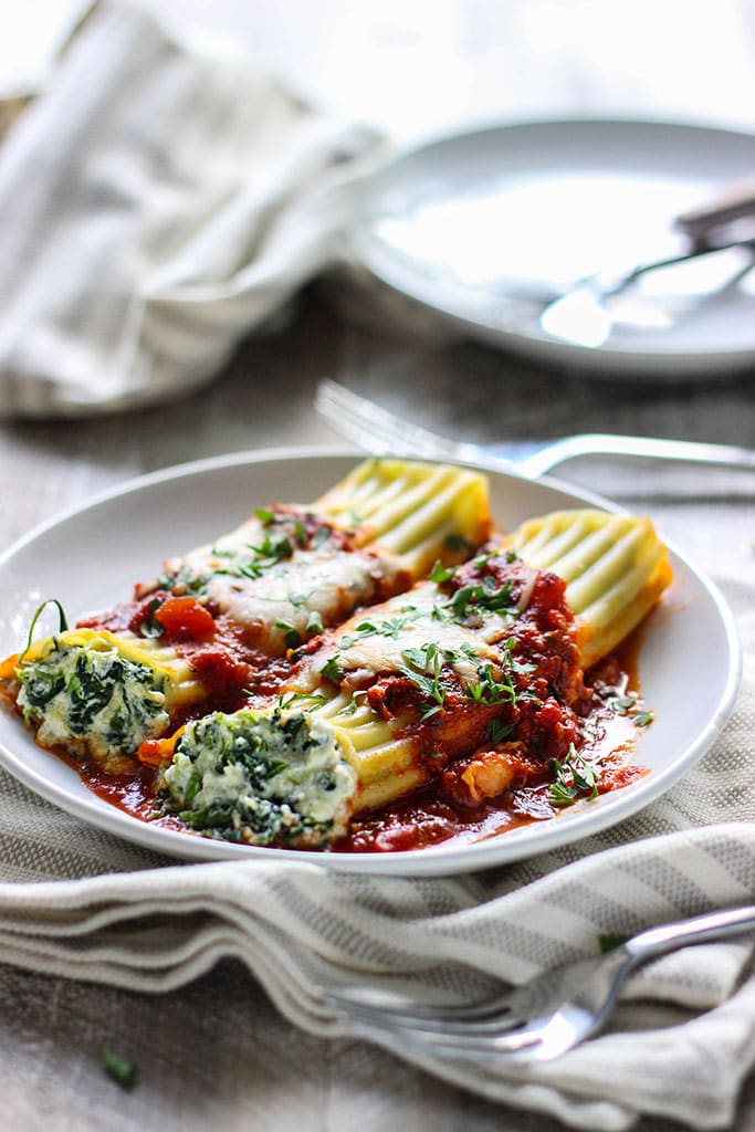 This spinach and three cheese manicotti is perfect for Italian food loving vegetarians. The perfect comfort food this fall.