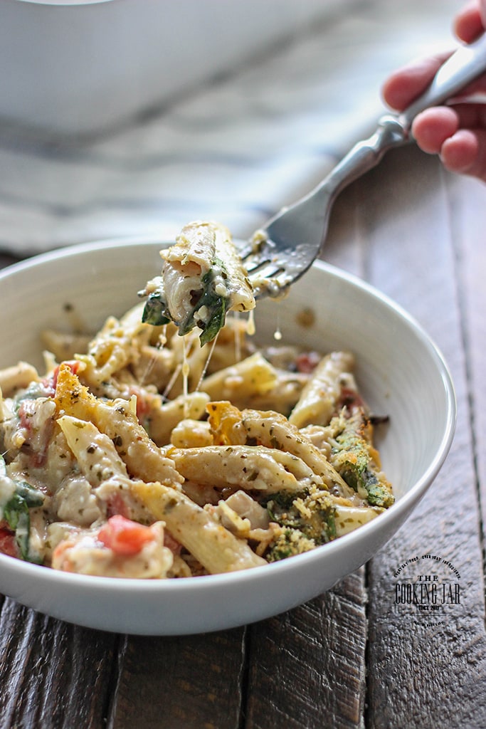 Turn store-bought ingredients into a hearty, comforting pesto chicken pasta bake. Super easy to put together for a delicious, big portioned family meal!