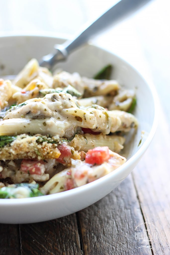 Turn store-bought ingredients into a hearty, comforting pesto chicken pasta bake. Super easy to put together for a delicious, big portioned family meal!