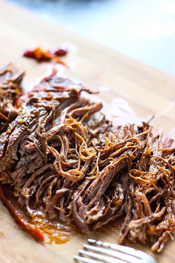 Fork-tender strands of pull apart flank steak simmering in a spicy tomato sauce makes this slow cooker Ropa Vieja something you should not miss.