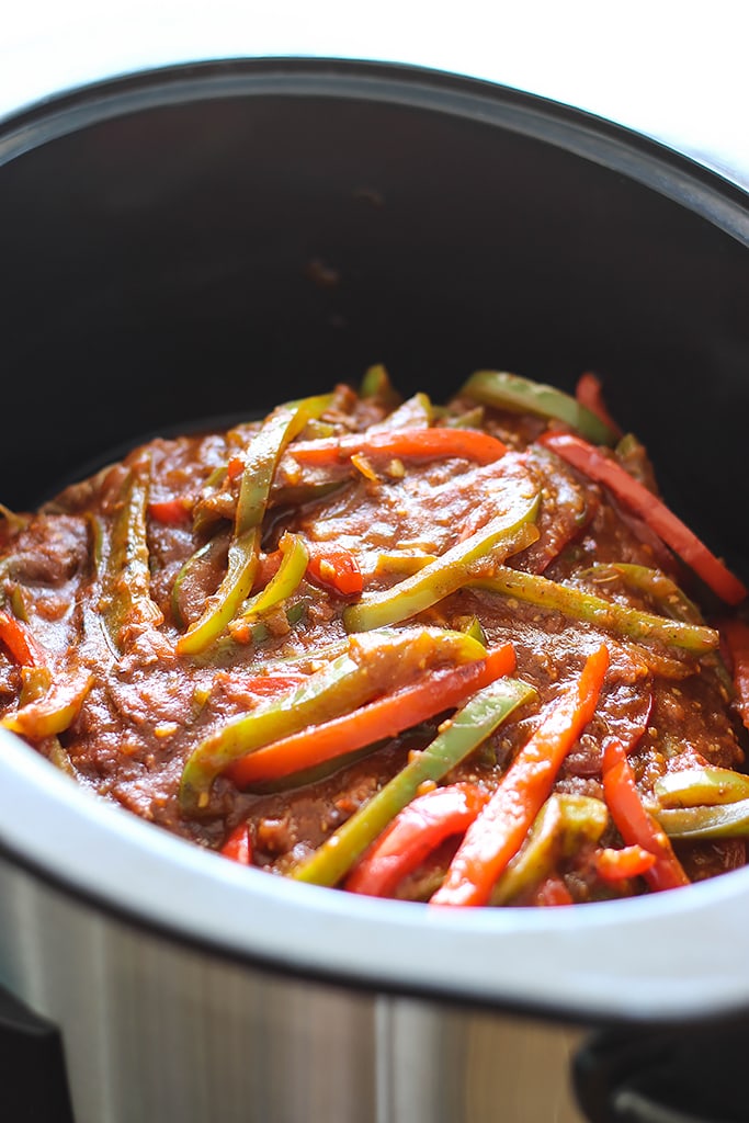 Fork-tender strands of pull apart flank steak simmering in a spicy tomato sauce makes this slow cooker Ropa Vieja something you should not miss.