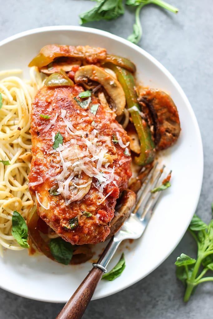 Skillet chicken cacciatore stewed in a robust red sauce with fresh peppers, mushrooms and basil is a hearty meal for 4. Serve over pasta with Parmesan cheese.