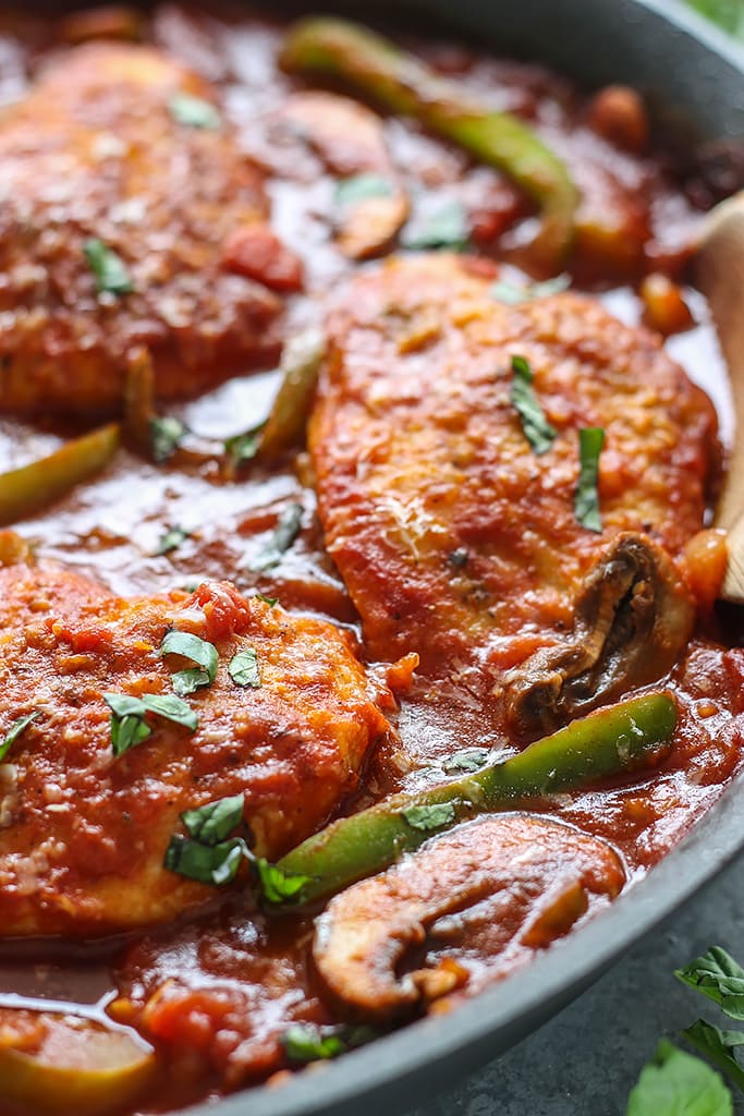 Skillet chicken cacciatore stewed in a robust red sauce with fresh peppers, mushrooms and basil is a hearty meal for 4. Serve over pasta with Parmesan cheese.