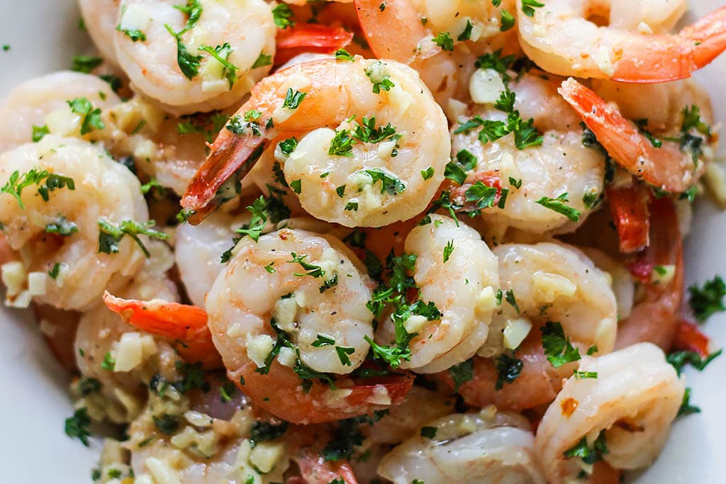 Enjoy a 20 minute meal with easy shrimp scampi; seared shrimp in a garlic buttery sauce with a hint of lemon, parsley and served over a bed of your favorite pasta.