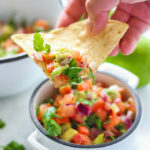 A quick and easy recipe for Pico De Gallo (Salsa Freca) with fresh avocado, tomatoes, red onions, lemon juice and cilantro. Use it as a dip or topping for tacos!