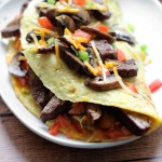 An IHOP copycat recipe for Big Steak Omelette: a giant omelette stuffed to the brim with steak, bell peppers, onions, cheese, hash browns and mushrooms!