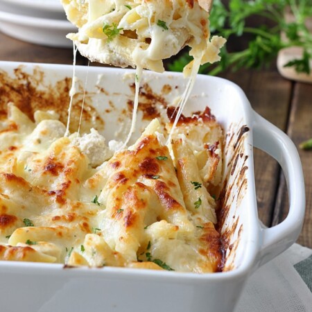 Chicken Alfredo pasta bake in a white casserole dish.