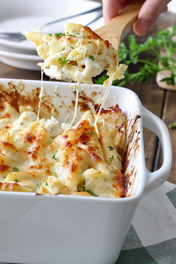 Creamy, cheesy packed chicken Alfredo pasta bake with three kinds of cheese and plenty to go around. Lots of gooey, stringy cheese in this fall casserole!