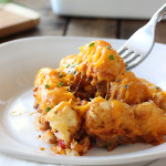 Some sloppy Joe tater tot casserole cheese strings with a fork.