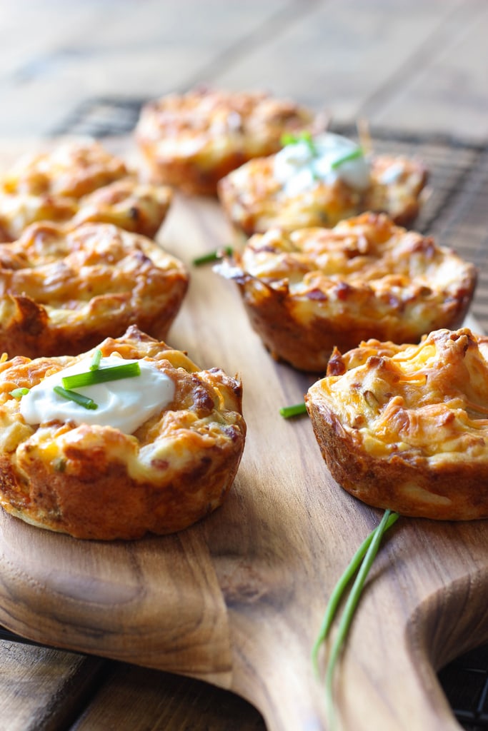 Several mashed potato puffs topped with sour cream and fresh chopped chives.