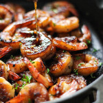 Honey garlic shrimp in a cast iron pan.