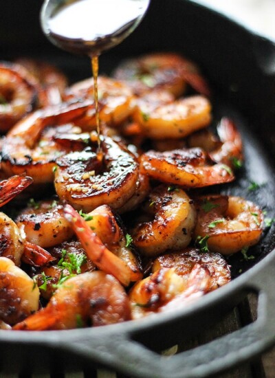 Honey garlic shrimp in a cast iron pan.