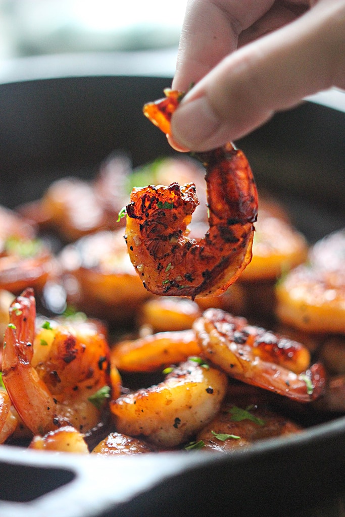 Honey garlic shrimp in a cast iron pan.