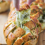 There's plenty of cheese action in this cheesy pesto pull-apart bread. Feed a crowd with this easy 4 ingredient appetizer.