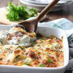 A tortellini Alfredo spinach pasta bake in a white casserole dish.