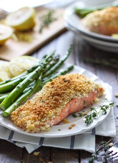 A plate of lemon Parmesan crusted salmon with asparagus on the side.