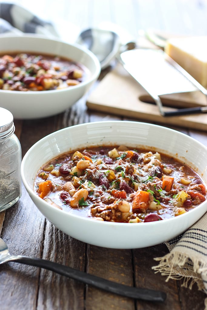 Some pasta e fagioli in two white bowls.