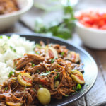 Fork-tender strands of pull apart flank steak simmering in a spicy tomato sauce makes this slow cooker Ropa Vieja something you should not miss.