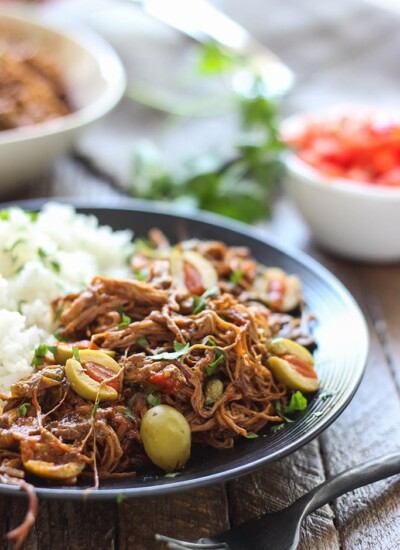 Fork-tender strands of pull apart flank steak simmering in a spicy tomato sauce makes this slow cooker Ropa Vieja something you should not miss.