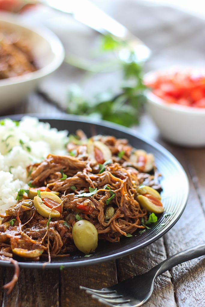 Fork-tender strands of pull apart flank steak simmering in a spicy tomato sauce makes this slow cooker Ropa Vieja something you should not miss.