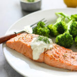 A quick and easy recipe for salmon in creamy dill sauce for two. Seasoned baked salmon paired with a sour cream sauce infused with lemon and fresh dill.