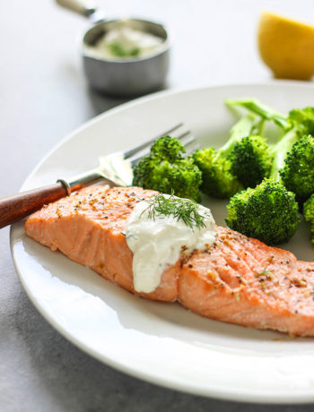 A quick and easy recipe for salmon in creamy dill sauce for two. Seasoned baked salmon paired with a sour cream sauce infused with lemon and fresh dill.