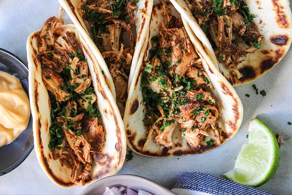 Set and forget these slow cooker shredded chicken tacos then enjoy fork-tender, authentic tasting, flavorful chicken. Pair it with your favorite toppings!