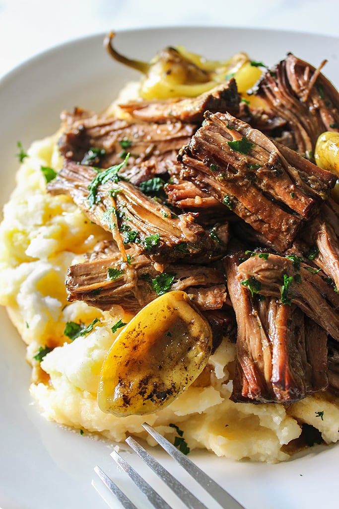 Shredded Mississippi pot roast on a bed of mashed potatoes and gravy.